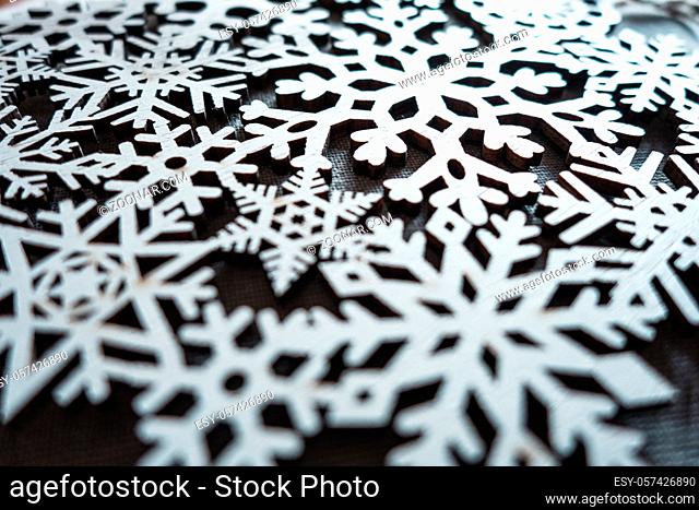 Wooden snowflake christmas ornament. Background decoration