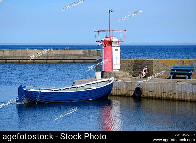 Small boat at quay in Brantevik harbor in Scania, Sweden, Scandinavia
