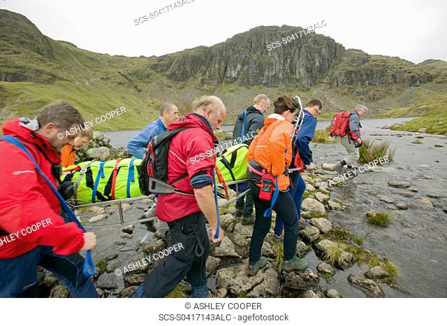 The Langdale Ambleside Mountain Rescue Team stretcher an injured hiker of the Langdale Fells in the Lake District UK