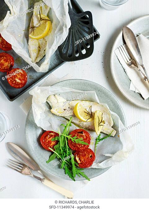 Seabass baked in parchment with roasted tomatoes with rocket