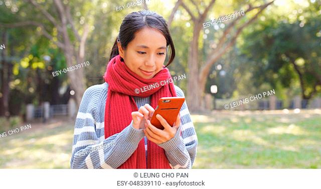 Woman use of smart phone in the park