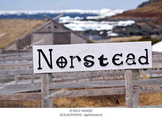 Sign at the entrance to the Norstead Viking Site a Viking Port of Trade backdropped by pack ice in the harbour, Viking Trail, Great Northern Peninsula
