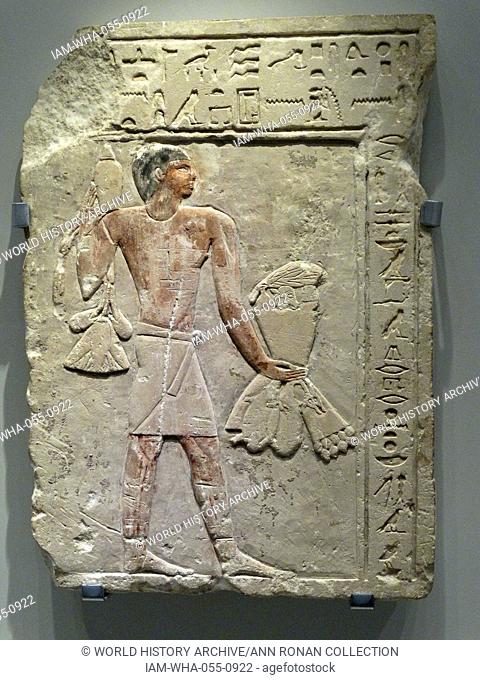 Fragmentary tomb relief inscribed with a magical formula, depicting an offering bearer carrying provisions. From the 26th-25th century BC