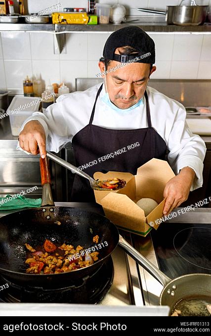 Chef preparing food parcel in restaurant kitchen