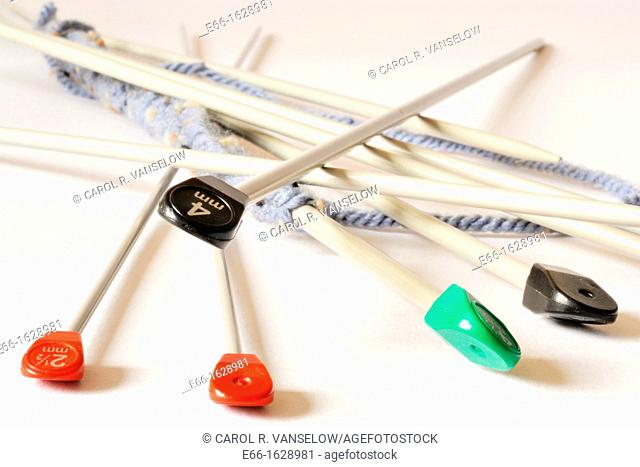 knitting needles scattered on white background like Mikado game