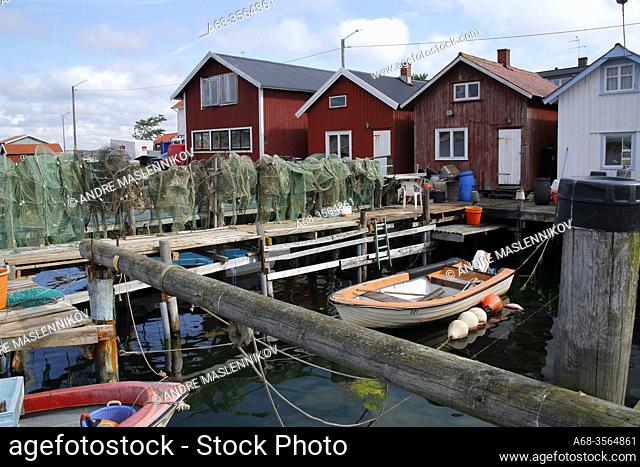 Fishermen's boathouses, fishing gear, boat and jetty in the harbor at Resö, Bohuslän, Sweden. Photo: André Maslennikov