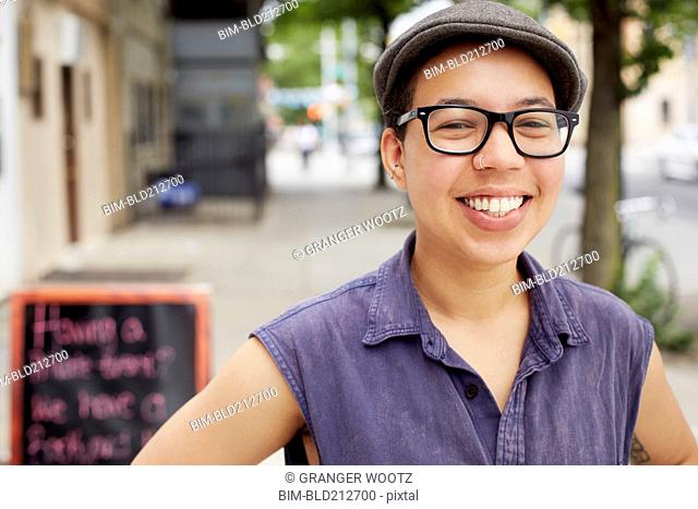 Mixed race woman smiling on city street