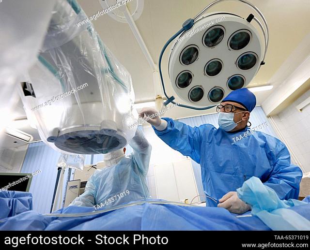 RUSSIA, IVANOVO - NOVEMBER 30, 2023: Yevgeny Varentsov (R), head of the urology department, performs a lithotripsy using thulium fibre laser at City Clinical...
