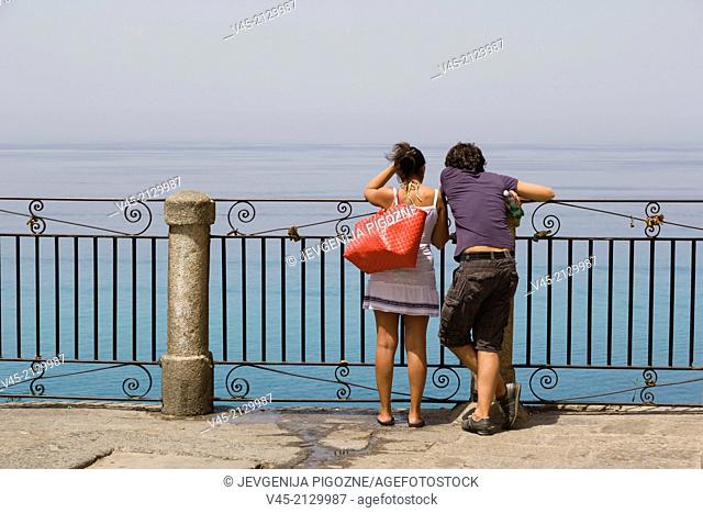 A couple enjoying the view from the terrace of Corso Vittorio Emmanuele, Tropea, Vibo Valentia, Calabria, Southern Italy, Italy