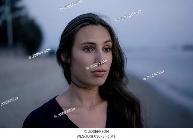 Germany, Hamburg, portrait of beautiful teenage girl at Elbe shore in the evening