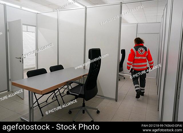 18 December 2020, Saxony, Chemnitz: An employee of the German Red Cross walks through the rooms at the Chemnitz Vaccination Centre