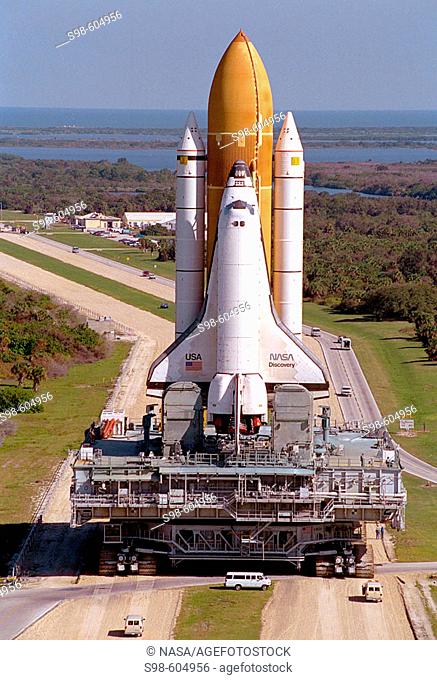 The Space Shuttle Discovery completes the final Earth-bound portion of its journey into space, leaving the Vehicle Assembly Building on the slow trip to Launch...