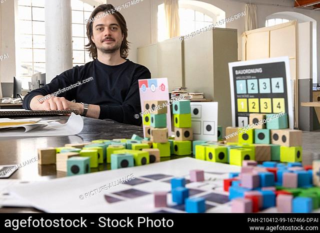 01 April 2021, Thuringia;Thuringia, Weimar: Game developer Janosh Kozák designs board games that he sells to a game publisher or finances with the crowdfunding...