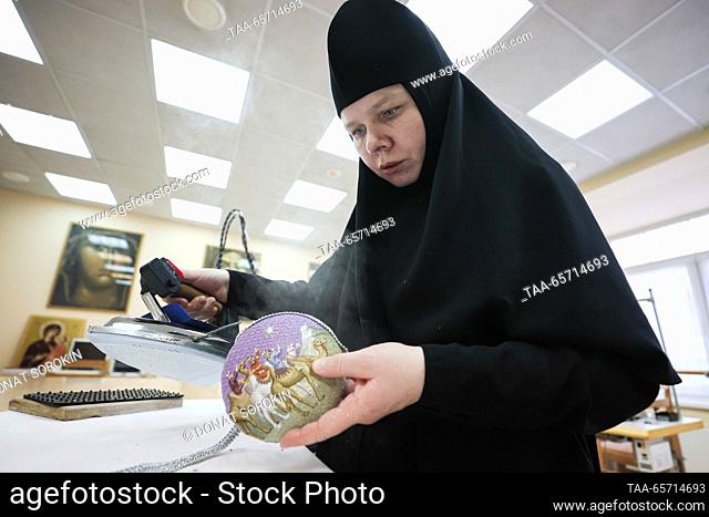 RUSSIA, YEKATERINBURG - DECEMBER 13, 2023: A nun irons a Christmas bauble handmade at a sewing workshop of Alexander Nevsky Novo-Tikhvinsky Convent