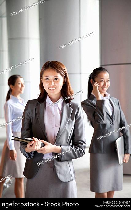 Three young businesswomen outside, portrait