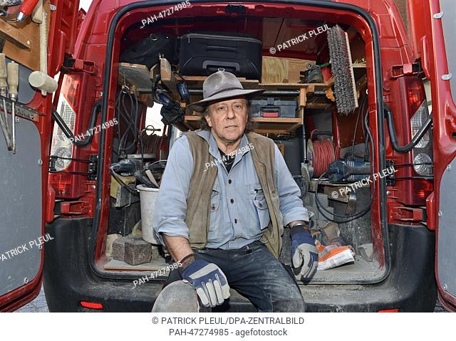 Artist Gunter Demnig sits in the back of his van after installing Stolpersteins to commemorate deported Jews in Beeskow,  Germany, 20 March 2014