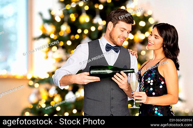 happy couple drinking champagne at christmas party