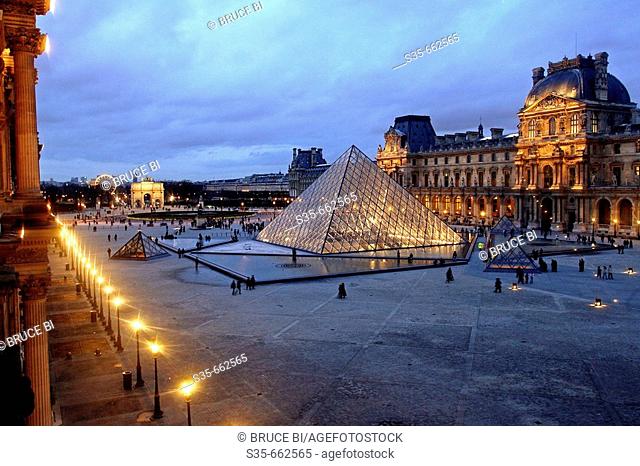 The night view of Cour Napoleon of Musee Louvre from Denon Wing. Paris. France