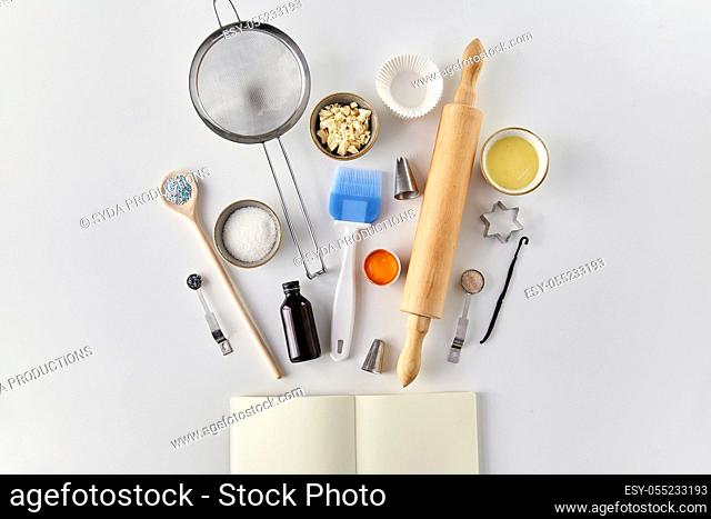 recipe book and cooking ingredients on table