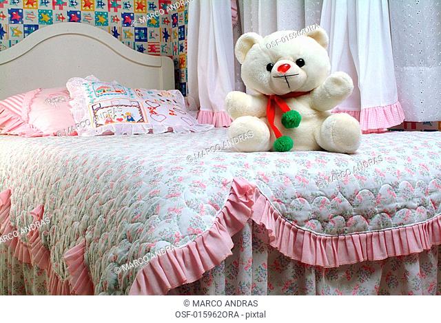 a teddy bear plushed toy on the bed