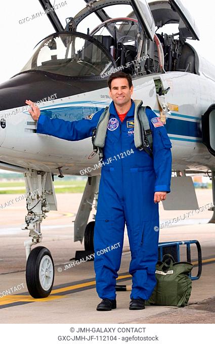 Astronaut Greg Chamitoff, STS-124 mission specialist, takes a moment for a photo near a NASA T-38 trainer jet prior to a flight from Ellington Field near NASA's...