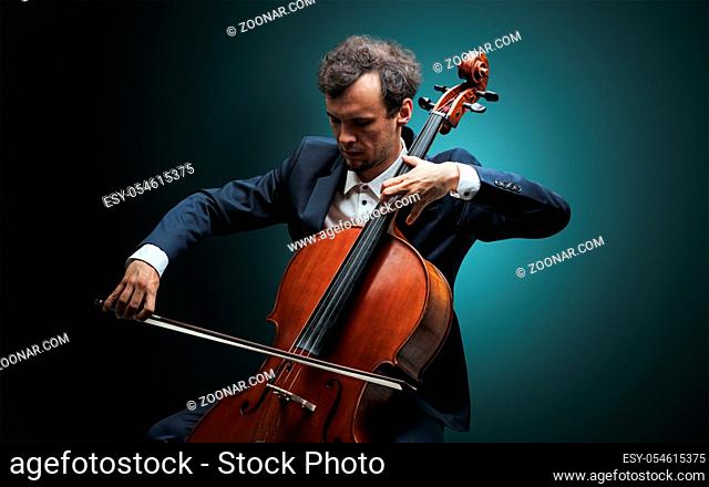 Lonely cellist composing on cello with nothing around