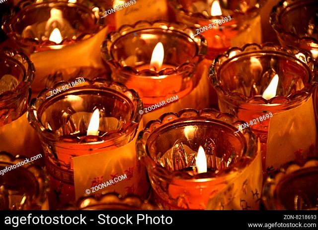 Temple candles in red and yellow transparent chandeliers