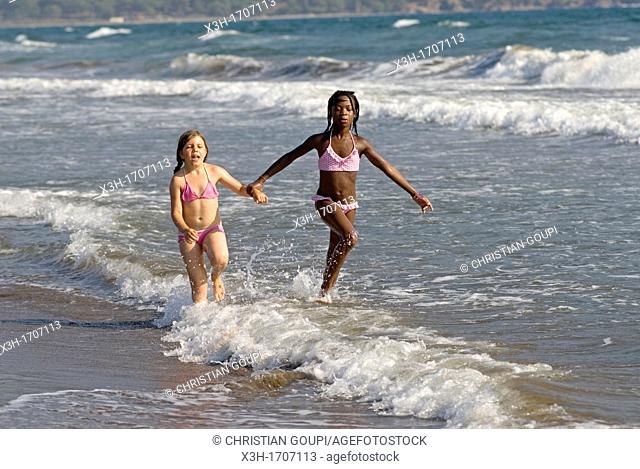 children playing in the waves of the Iztuzu beach, Dalyan, Turkey, Eurasia