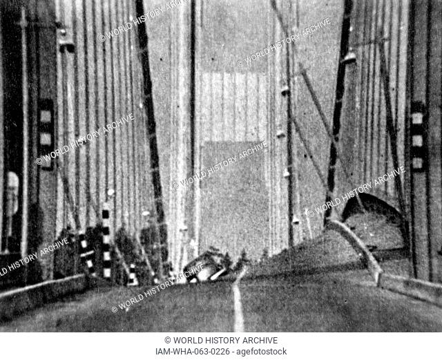 Photographic print of the original Tacoma Narrows Bridge before it's wind induced collapse. The print depicts the physical phenomenon known as aerolastic...