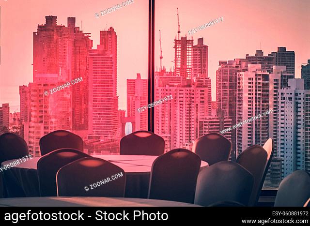 empty conference room with view over modern skyline during sunset