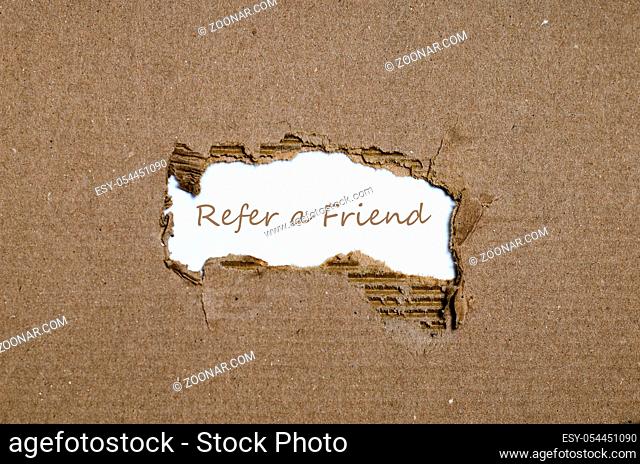The word refer a friend appearing behind torn paper
