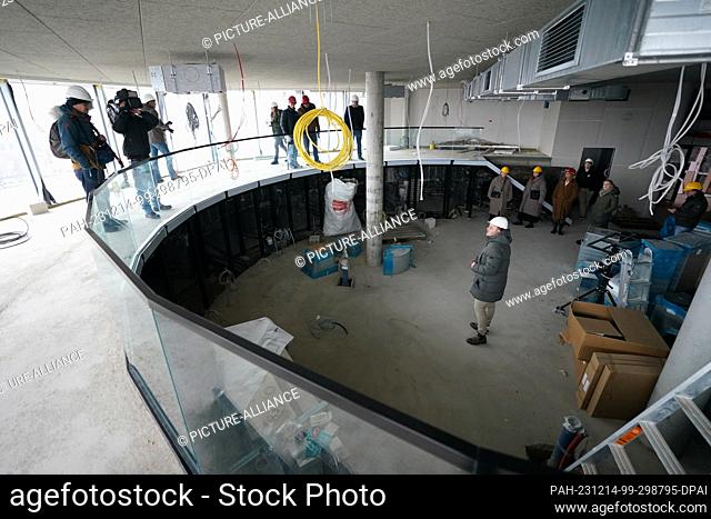 14 December 2023, Hamburg: Media representatives visit a former flak tower and future restaurant during a tour of the greened St. Pauli bunker