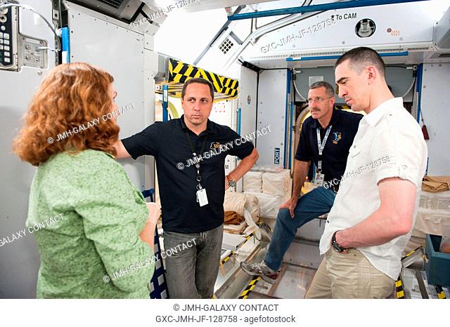 NASA astronaut Dan Burbank (background), Expedition 29 flight engineer and Expedition 30 commander; along with Russian cosmonauts Anatoly Ivanishin (right) and...