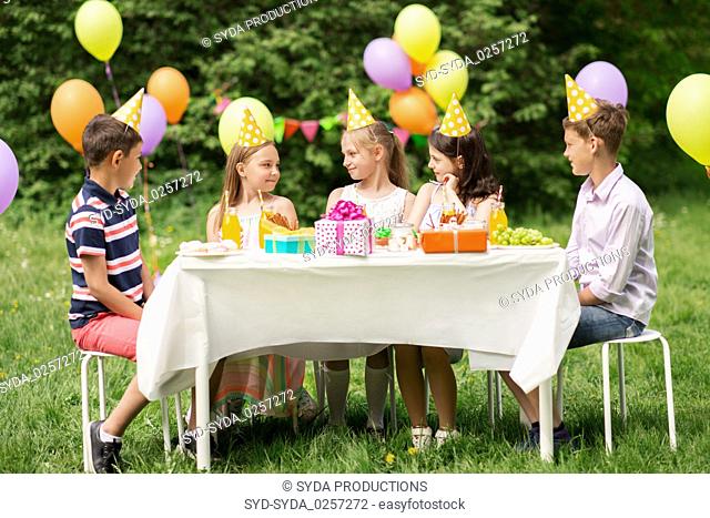 happy kids on birthday party at summer garden