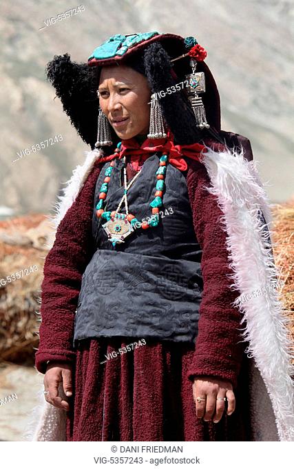 INDIA, RANGDUM, 27.06.2014, Ladakhi woman dressed in a traditional outfit and wearing a perak headdress in a small village in Rangdum, Ladakh, Jammu and Kashmir