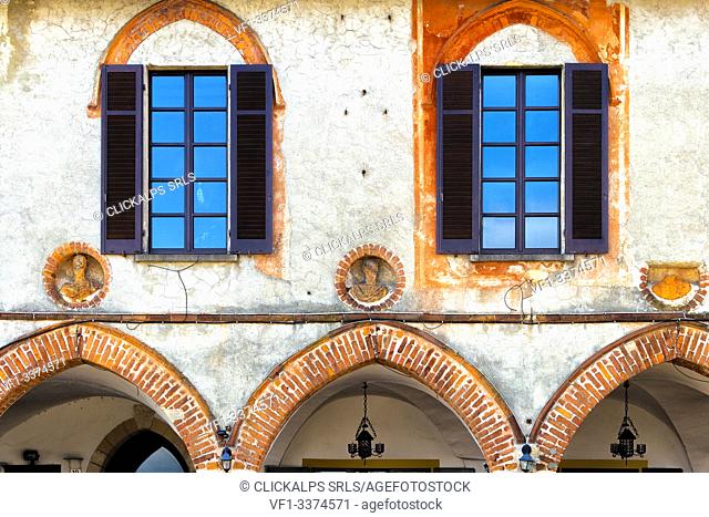 Gothic arches on the facade of the Broletto(courthouse). Arona, Lake Maggiore, Piedmont, Italy, Europe