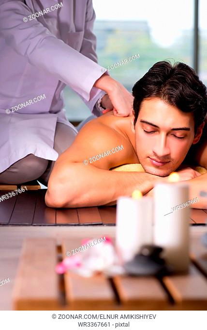 Young handsome man during spa procedure