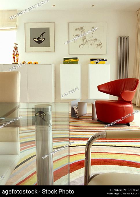 Red leather chair on multicoloured stripe rug