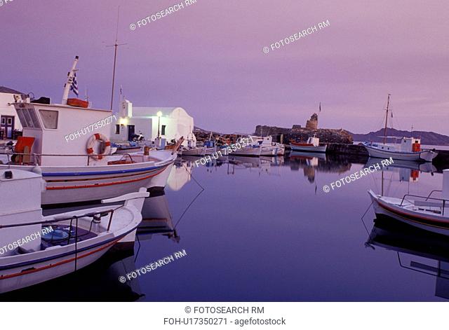 Greece, Paros, Greek Islands, Naoussa, Cyclades, Europe, Fishing boats docked on the waterfront on Naoussa Harbor on Paros Island on the Aegean Sea