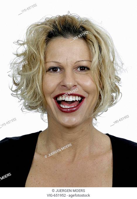 Portrait of a young pretty woman who looks joyfully. - DORSTEN, NORTH RHINE-WESTPHALIA, GERMANY, 25/02/2008