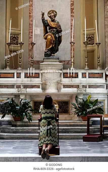 Woman praying to St. Peter in church, Galatina, Lecce, Italy, Europe