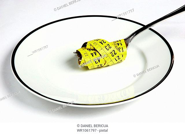 Measuring Tape and Fork on Plate