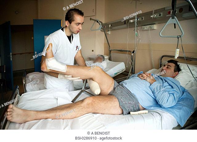 Photo essay from La Croix Saint-Simon Hospital, Paris, France. Department of orthopedics. Physical therapist and patient with a fracture of the ankle