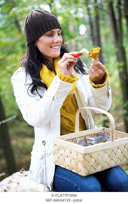 A woman cleaning mushrooms outside an autumn day, Sweden