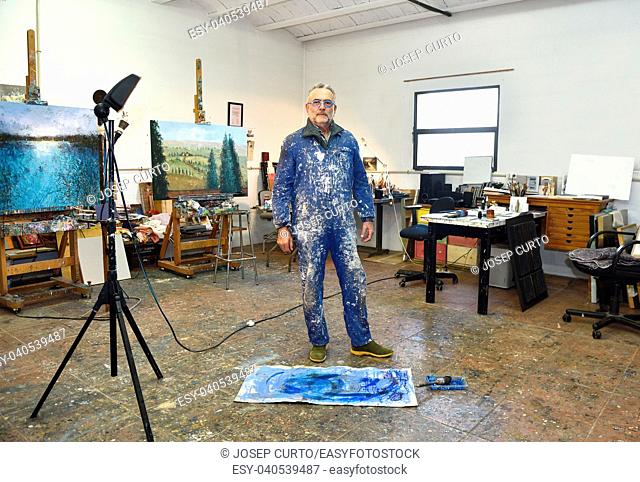 portrait of a painter artist who works in his studio