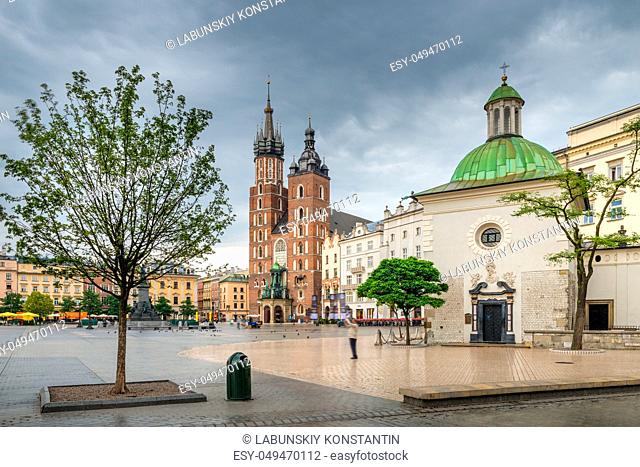 The Catholic Church of Mary and the Church of St. Adalbert on the main square of Krakow on a rainy day