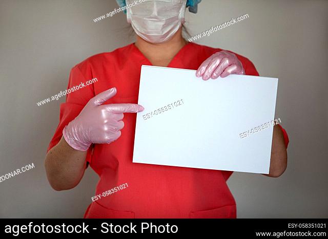 Women doctor wearing gloves and mask to fight coronavirus pandemic covid-2019. She holding empty paper