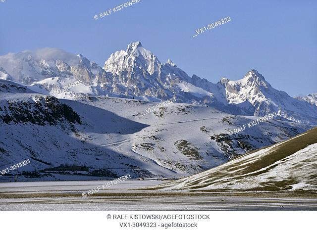 View to snow covered mountains, Grand teton Range over National Elk Refuge in winter, nice winter day, Wyoming, USA