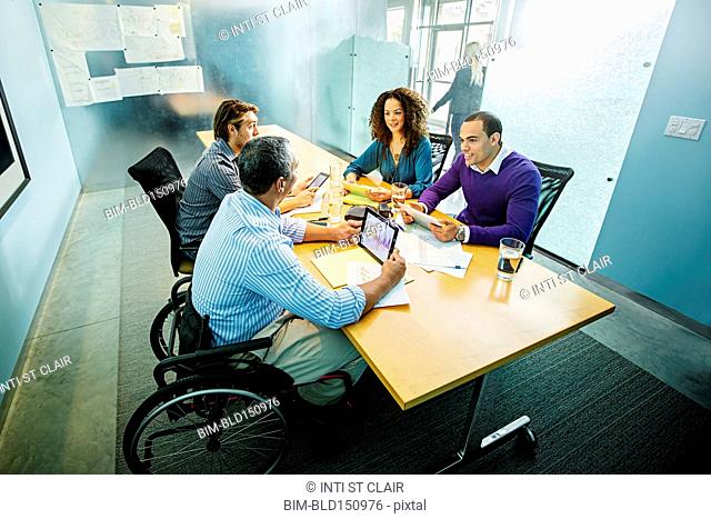 Business people using digital tablets in office meeting