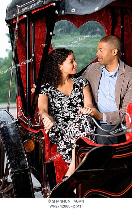 Couple sat in horse drawn carriage